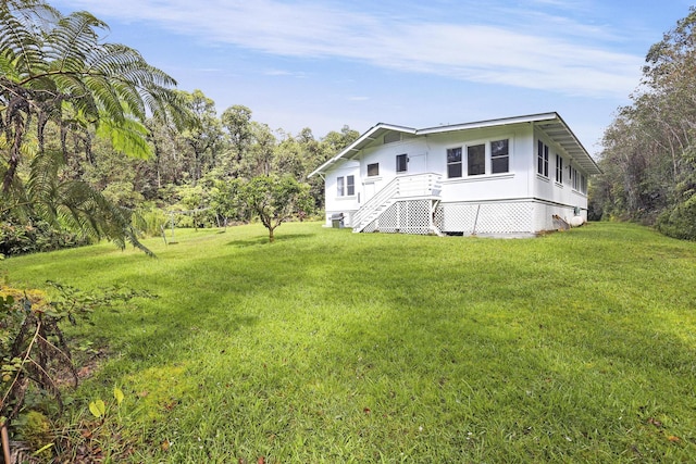 rear view of house featuring a lawn