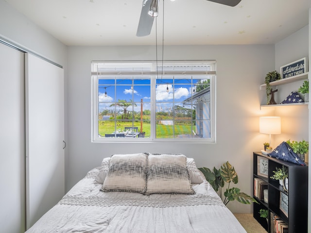 bedroom featuring ceiling fan and a closet