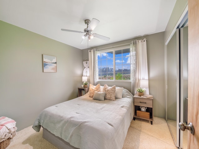 carpeted bedroom with a closet and ceiling fan