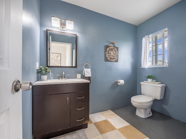 bathroom featuring vanity and toilet