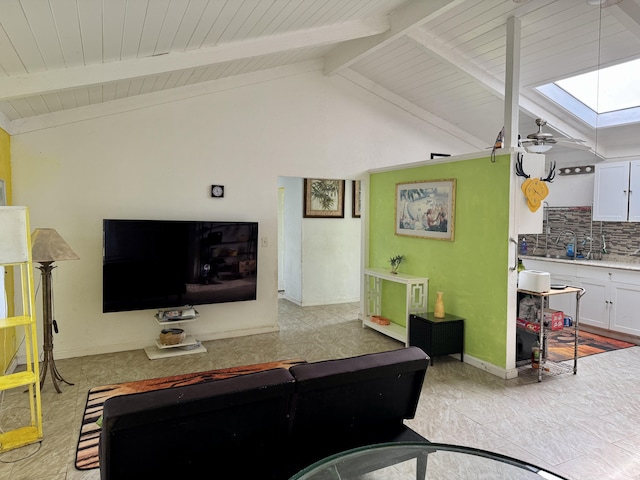 living room with ceiling fan and lofted ceiling with skylight