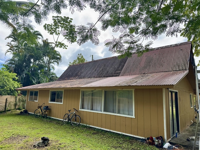 rear view of house featuring a lawn