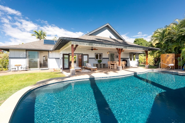 view of swimming pool with a bar, a patio, and ceiling fan