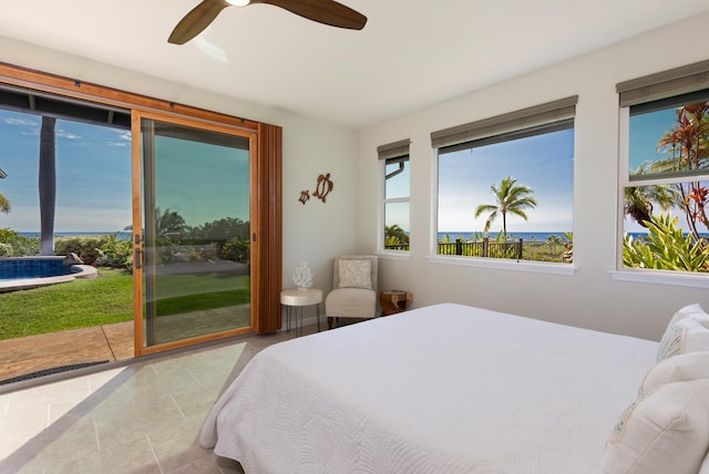 bedroom featuring access to exterior, ceiling fan, and a water view