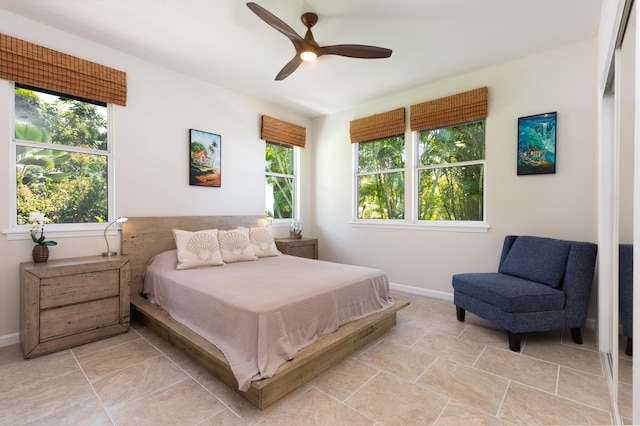 bedroom with ceiling fan and multiple windows