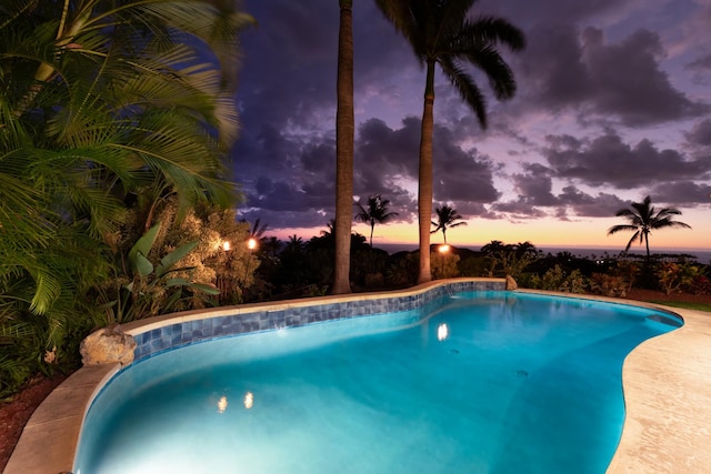 view of pool at dusk