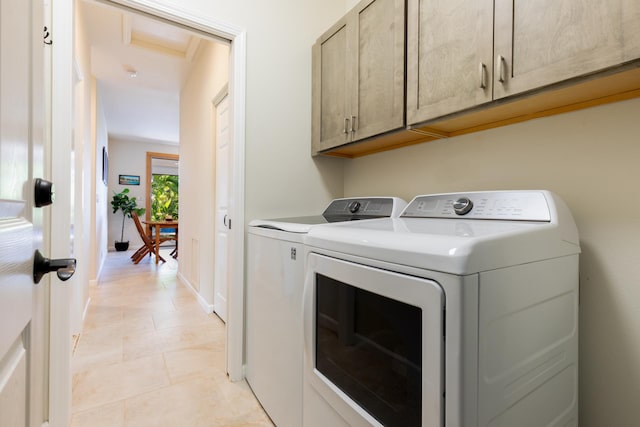 laundry area with cabinets and washer and clothes dryer