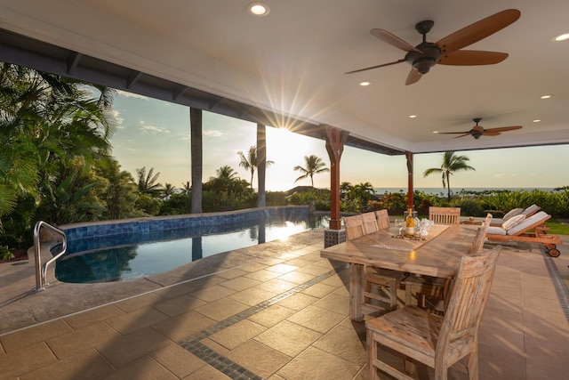 pool at dusk featuring a patio area