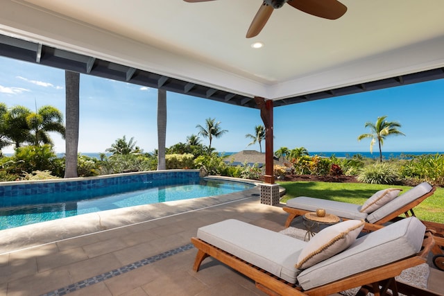 view of swimming pool with a water view, ceiling fan, and a patio area