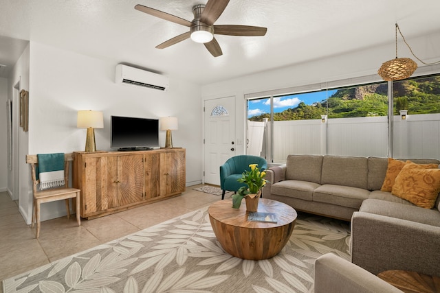 living room with a wall unit AC, ceiling fan, and light tile patterned flooring