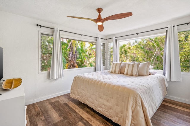 bedroom with ceiling fan and dark hardwood / wood-style flooring