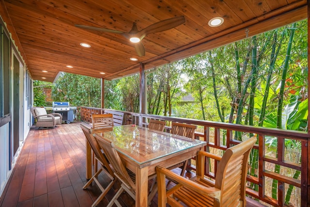 wooden terrace with grilling area and ceiling fan