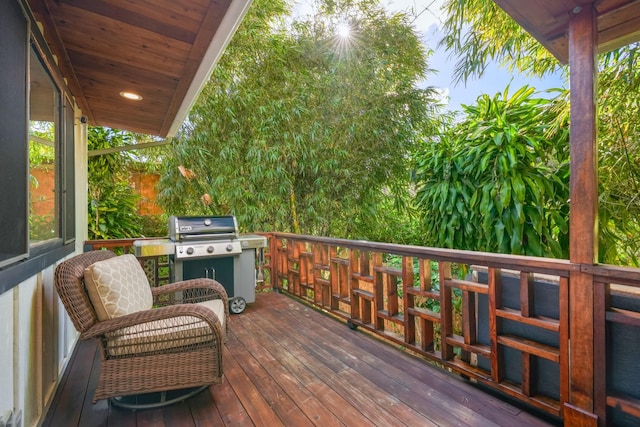 wooden terrace featuring a grill