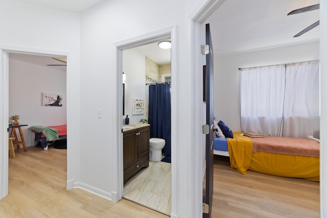 bathroom with ceiling fan, hardwood / wood-style floors, and vanity