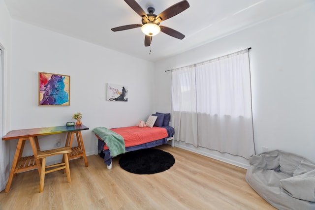 bedroom with ceiling fan and light hardwood / wood-style floors