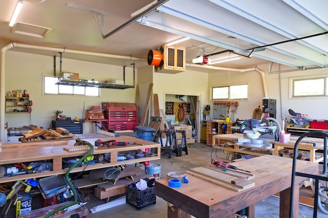 garage with a workshop area and a garage door opener