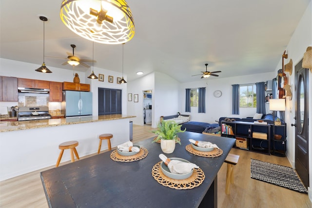 dining room with ceiling fan and light wood-type flooring