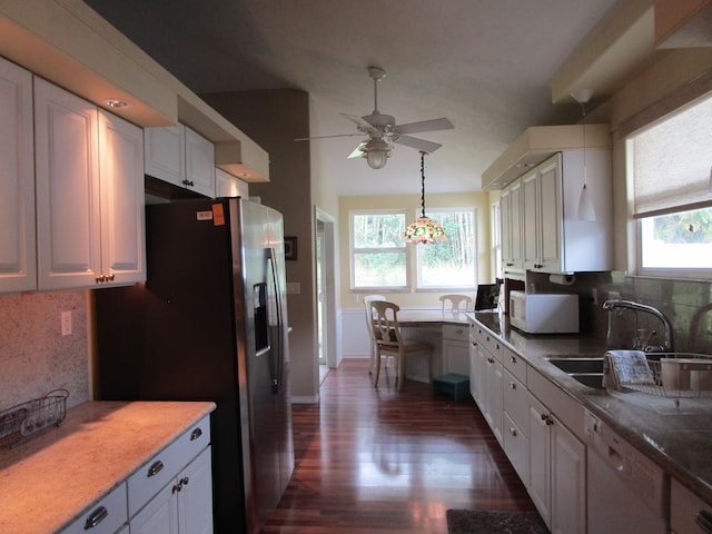 kitchen featuring white cabinetry, sink, plenty of natural light, white appliances, and decorative backsplash