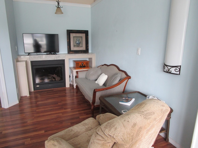 living room with dark hardwood / wood-style floors and crown molding