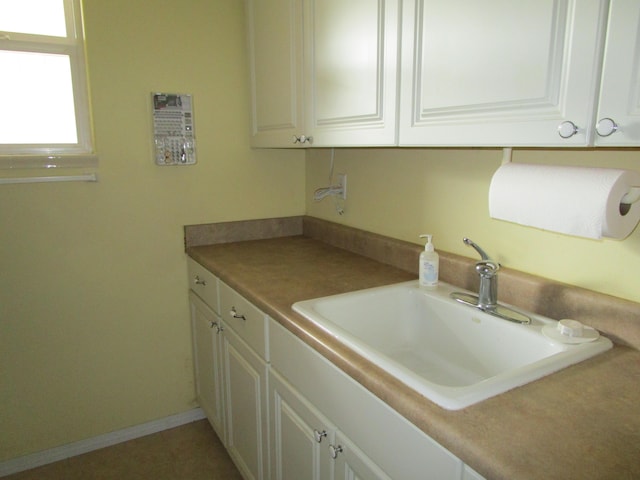 kitchen with sink and white cabinets