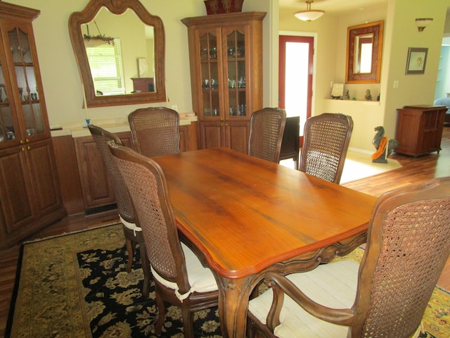 dining room with light wood-type flooring and plenty of natural light