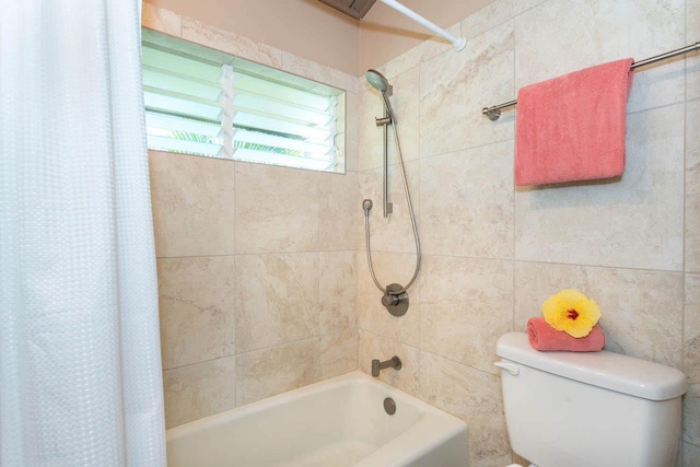 bathroom with shower / bath combo and toilet