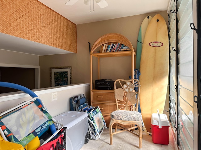 interior space with ceiling fan