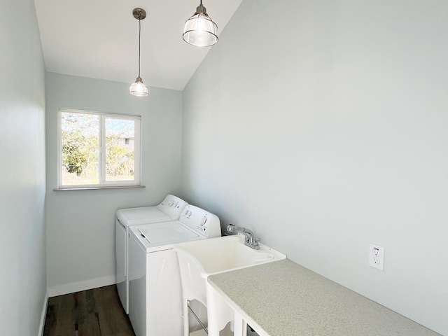 washroom with washer and dryer, sink, and dark hardwood / wood-style flooring