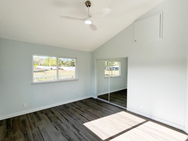 unfurnished bedroom featuring lofted ceiling, ceiling fan, a closet, and dark wood-type flooring