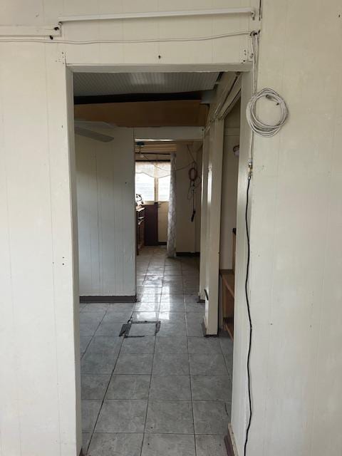 hallway with tile patterned flooring