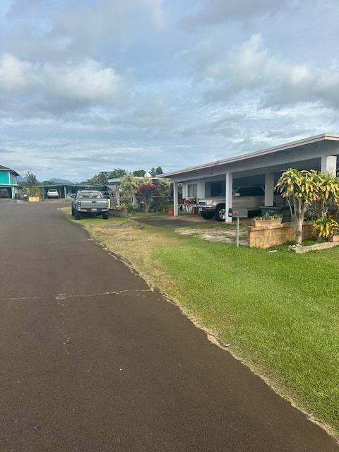 exterior space featuring a front yard and a carport