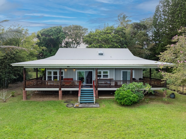 back of house with a wooden deck and a yard