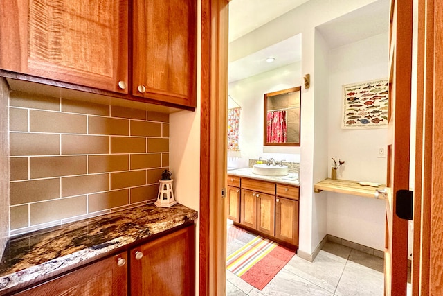 bathroom featuring vanity, decorative backsplash, and tile patterned flooring