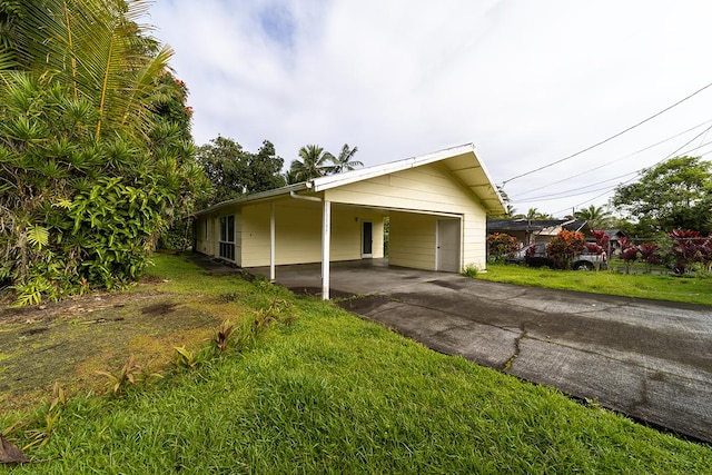 view of property exterior with a carport and a yard