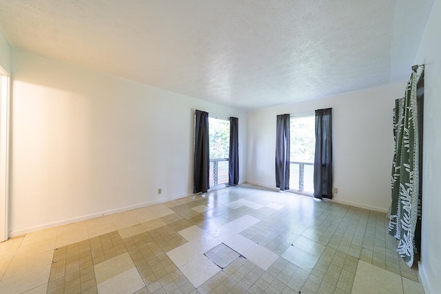 unfurnished room featuring a textured ceiling