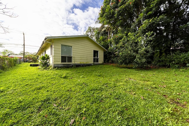 view of side of property featuring a yard