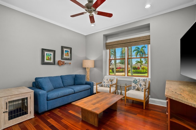 living room with dark hardwood / wood-style flooring, ceiling fan, and ornamental molding