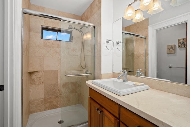 bathroom with vanity and a shower with shower door