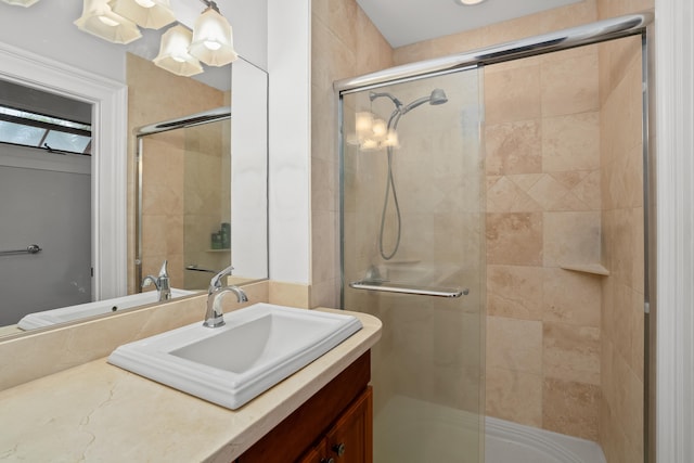 bathroom with vanity and a shower with door