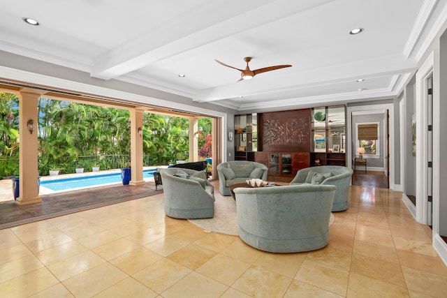 tiled living room featuring ceiling fan, beam ceiling, and ornamental molding