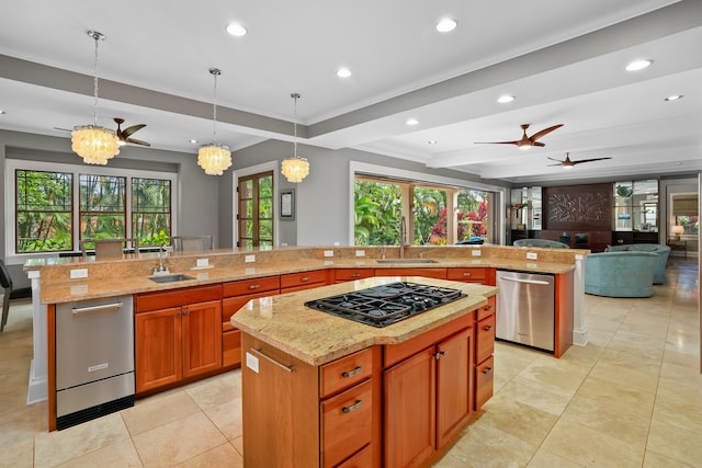 kitchen featuring gas cooktop, a large island with sink, decorative light fixtures, and dishwasher