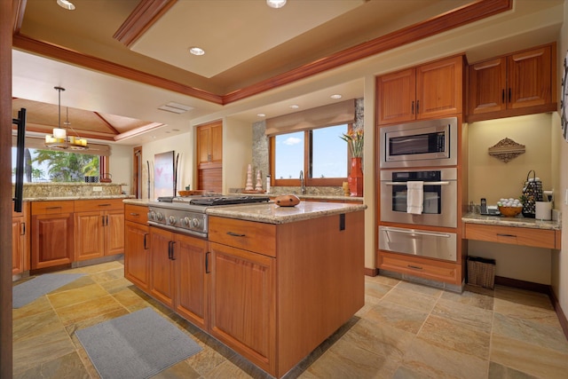 kitchen featuring appliances with stainless steel finishes, a raised ceiling, a kitchen island, decorative light fixtures, and kitchen peninsula