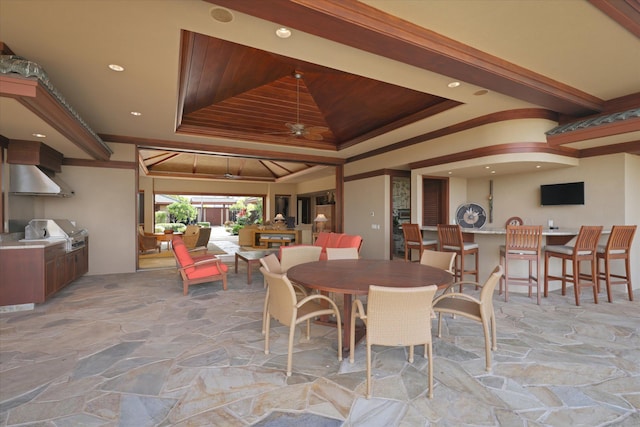 dining room featuring wood ceiling, a tray ceiling, and ornamental molding