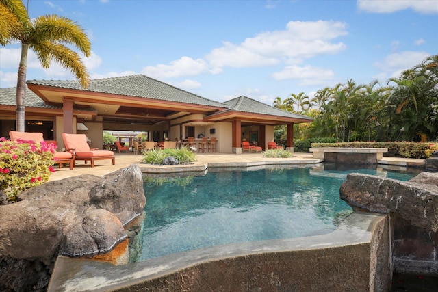 view of swimming pool featuring a hot tub and a patio