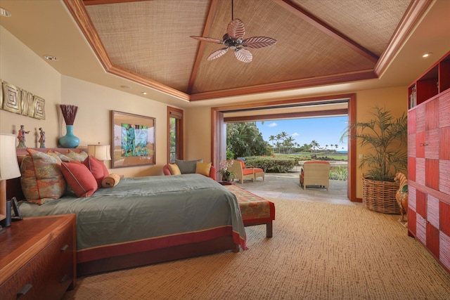 bedroom with crown molding, vaulted ceiling, a raised ceiling, ceiling fan, and access to exterior