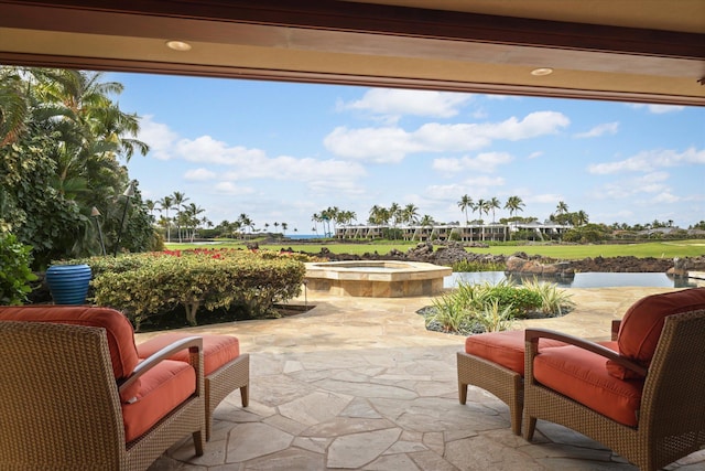 view of patio featuring an in ground hot tub