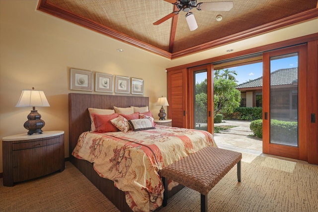 bedroom featuring crown molding, access to exterior, a tray ceiling, and ceiling fan