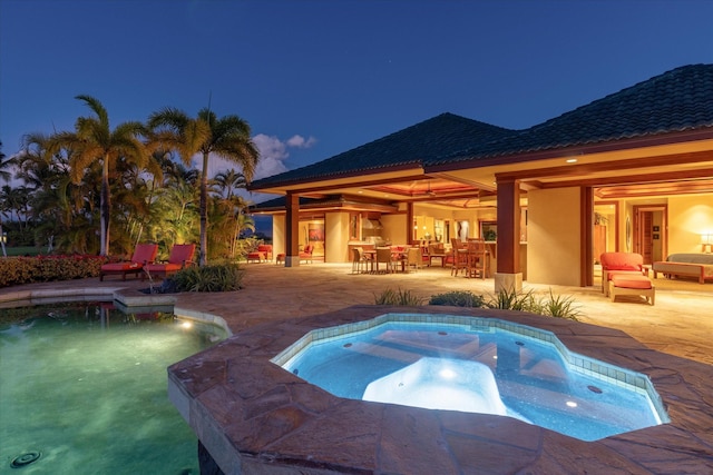 view of swimming pool featuring an in ground hot tub and a patio area