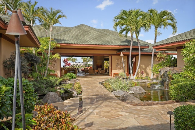 back of house with a gazebo and a patio