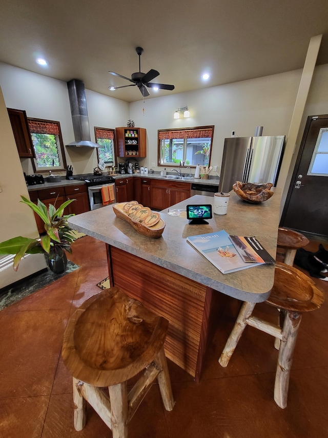 tiled dining area featuring ceiling fan and sink